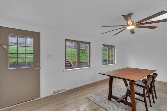unfurnished dining area featuring a ceiling fan, visible vents, light wood finished floors, and a healthy amount of sunlight