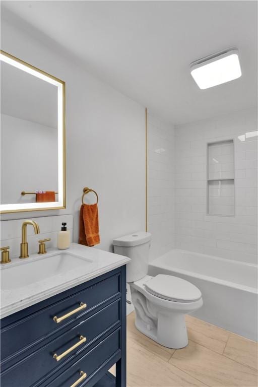 full bathroom featuring toilet, vanity, and tub / shower combination