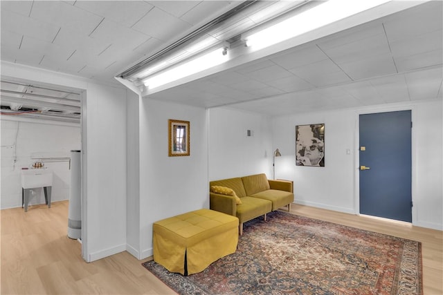 living area with wood finished floors and baseboards