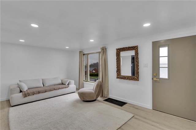 living area featuring wood finished floors, visible vents, and recessed lighting