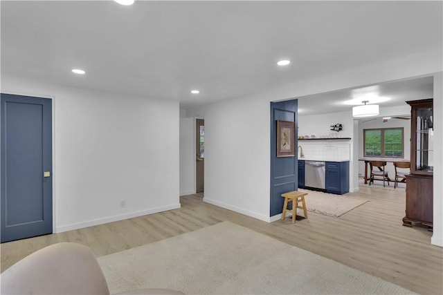 unfurnished living room featuring baseboards, light wood-type flooring, and recessed lighting