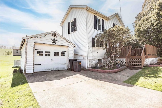 448 E Main St, Dayton, PA 16222 - exterior space featuring an outbuilding, a detached garage, a lawn, concrete driveway, and a deck