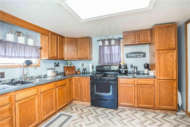 448 E Main St, Dayton, PA 16222 - kitchen with brown cabinetry, visible vents, a sink, and black gas range oven