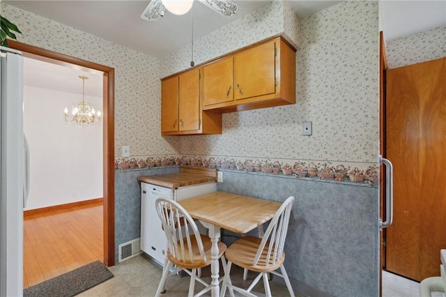 126 Peony Ave, Ross Twp, PA 15229 - dining space featuring visible vents, wallpapered walls, light tile patterned floors, and ceiling fan with notable chandelier
