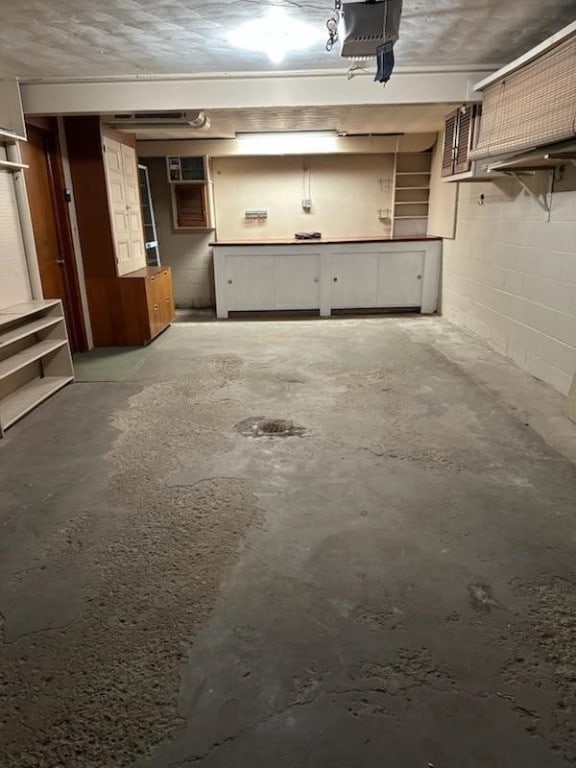 126 Peony Ave, Ross Twp, PA 15229 - garage featuring a garage door opener and concrete block wall