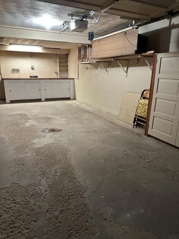 126 Peony Ave, Ross Twp, PA 15229 - garage with a garage door opener, visible vents, and concrete block wall