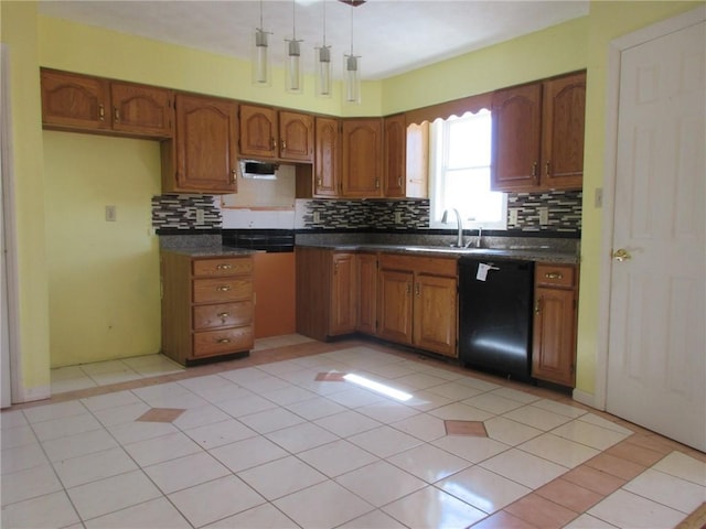 kitchen featuring brown cabinetry, black dishwasher, and dark countertops