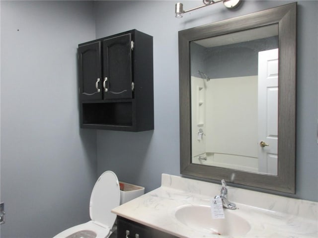 bathroom featuring toilet, vanity, and tub / shower combination