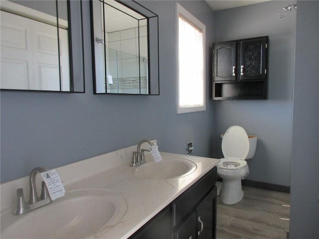 full bathroom with a sink, a wealth of natural light, and toilet