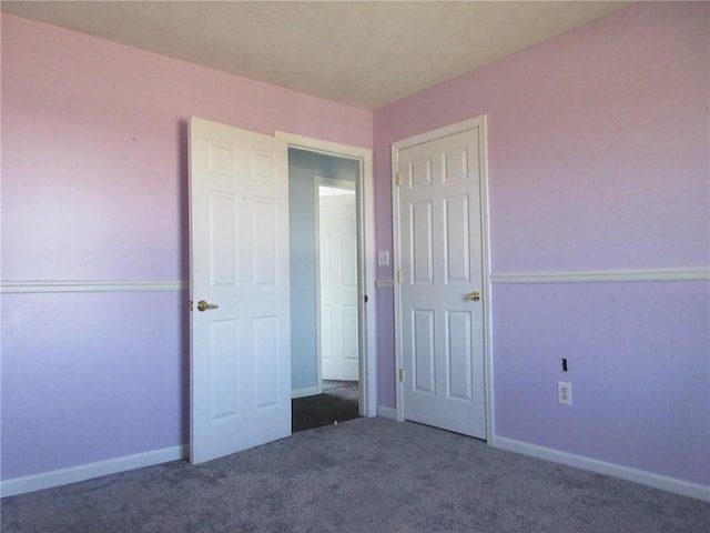 unfurnished bedroom featuring baseboards and carpet
