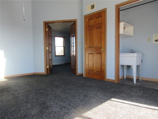 interior space featuring visible vents, a baseboard radiator, baseboards, and carpet floors
