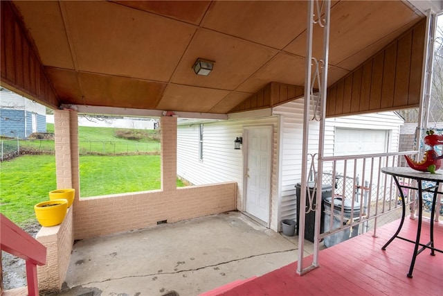 view of patio with a garage and fence
