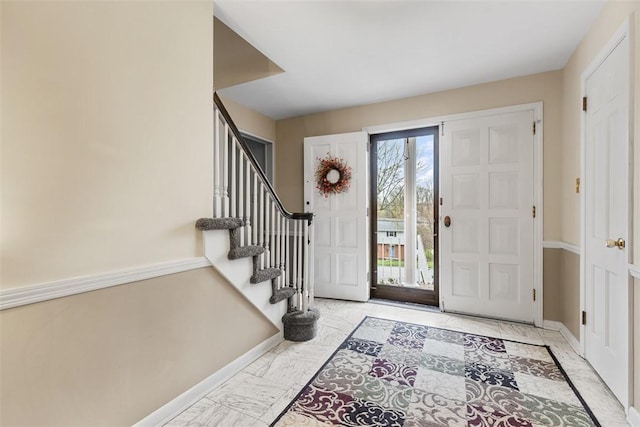 entryway featuring stairway, baseboards, and marble finish floor