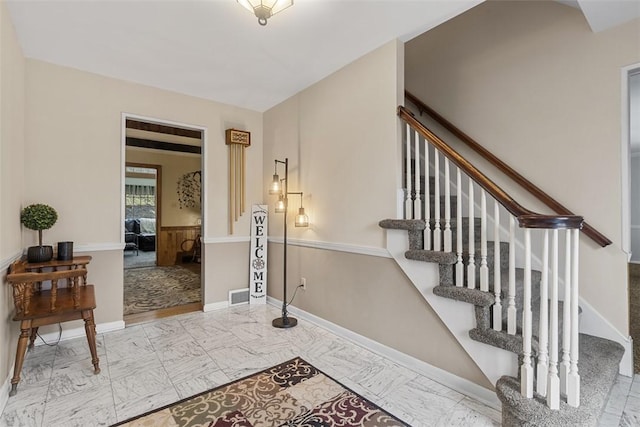 stairway featuring visible vents