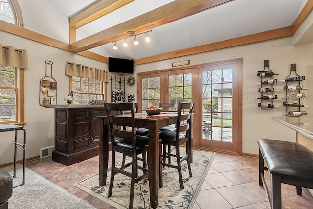 dining space featuring baseboards, light tile patterned flooring, and visible vents