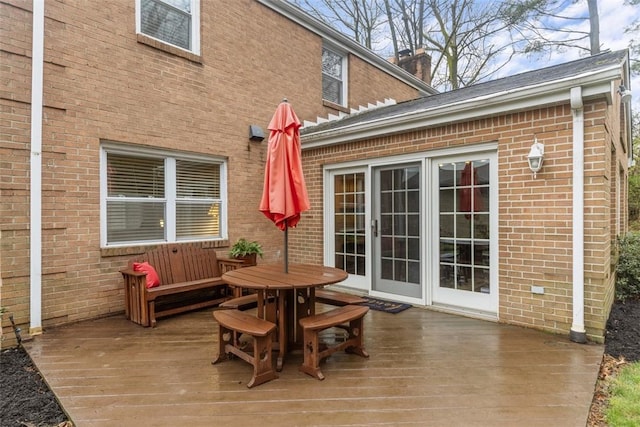 wooden terrace with outdoor dining space