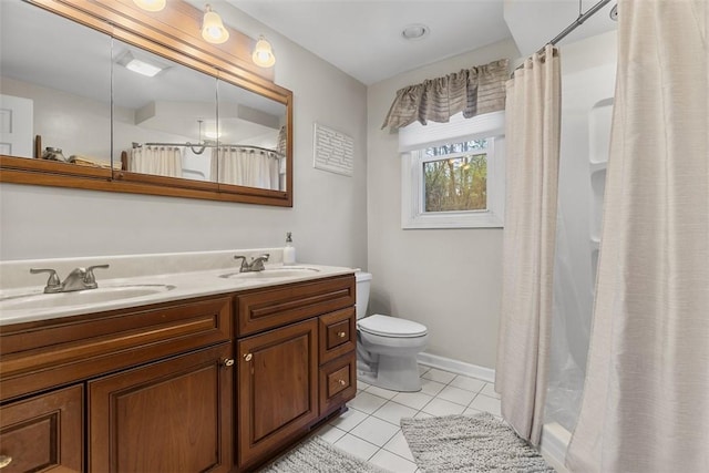 full bathroom featuring a sink, tile patterned flooring, toilet, and double vanity