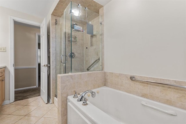 bathroom featuring vanity, tile patterned flooring, a stall shower, and a garden tub