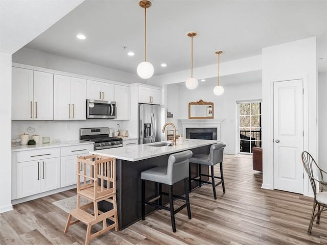 308 Thurgood Dr, Marshall, PA 15086 - kitchen featuring a kitchen breakfast bar, white cabinetry, a kitchen island with sink, stainless steel appliances, and a sink