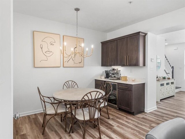 308 Thurgood Dr, Marshall, PA 15086 - dining room with light wood-type flooring, stairs, wine cooler, a notable chandelier, and baseboards