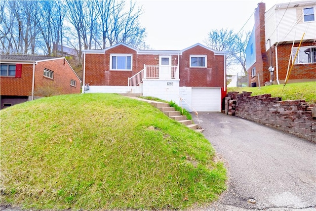 1282 Cook School Rd, Bridgeville, PA 15017 - view of front of property with an attached garage, driveway, a front lawn, and brick siding