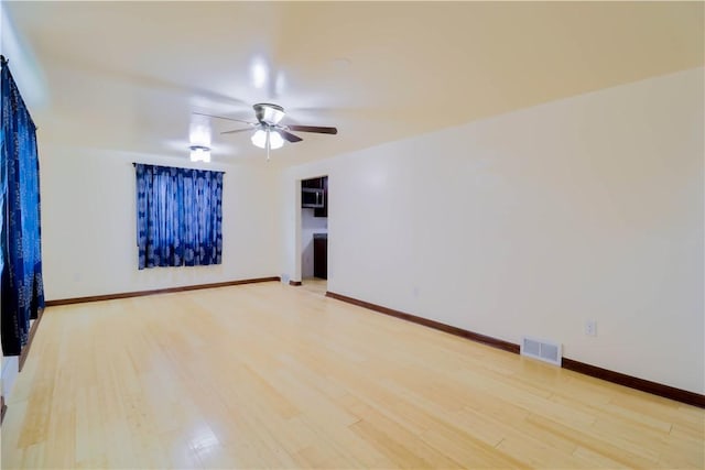 1282 Cook School Rd, Bridgeville, PA 15017 - spare room with light wood finished floors, visible vents, baseboards, and a ceiling fan