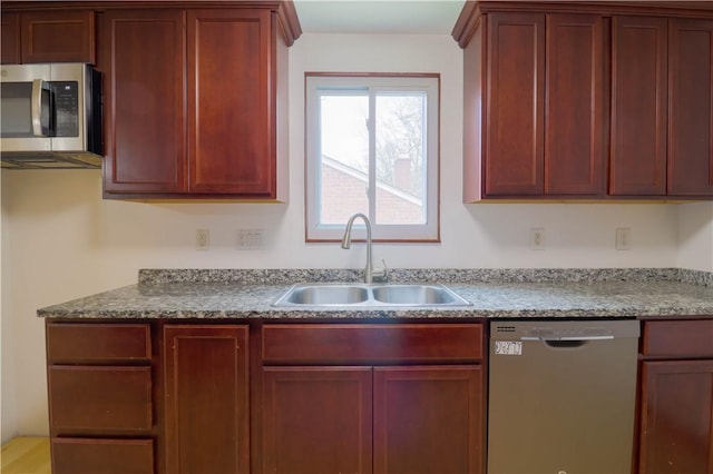 1282 Cook School Rd, Bridgeville, PA 15017 - kitchen with reddish brown cabinets, a sink, light stone countertops, and stainless steel appliances