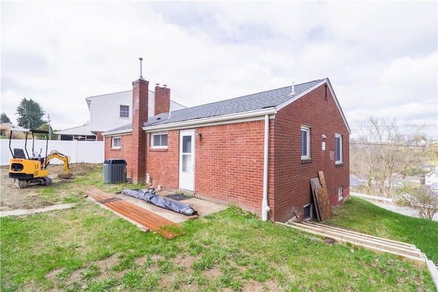 1282 Cook School Rd, Bridgeville, PA 15017 - rear view of property with a yard, a chimney, fence, central air condition unit, and brick siding