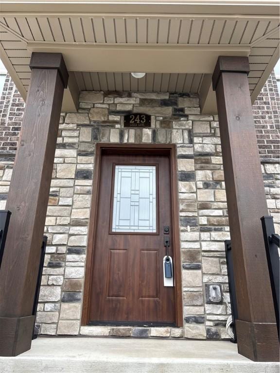 entrance to property featuring stone siding