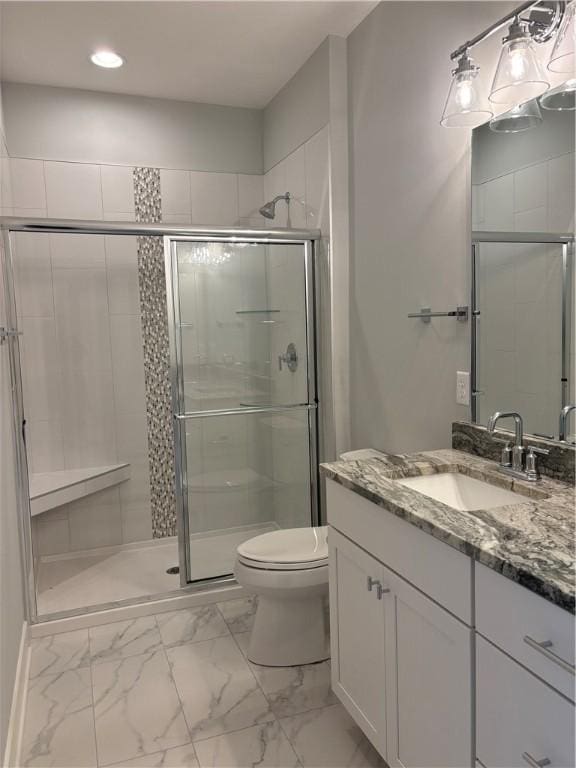 bathroom featuring vanity, a stall shower, recessed lighting, toilet, and marble finish floor
