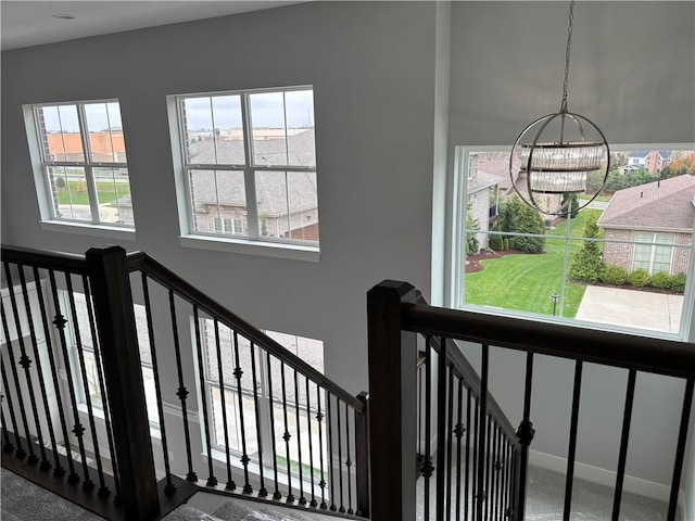 staircase featuring an inviting chandelier