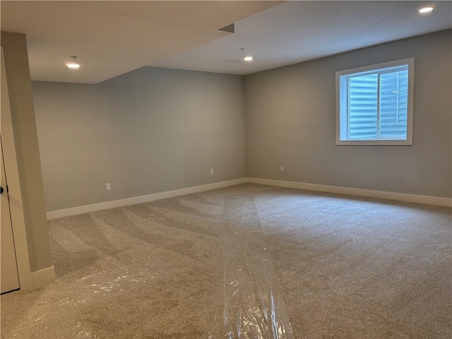 carpeted empty room with baseboards and recessed lighting