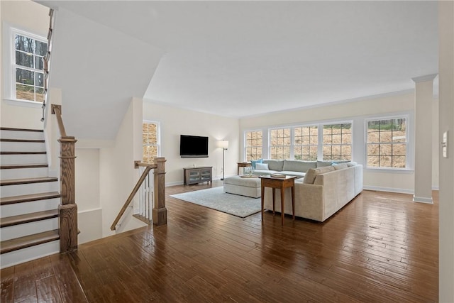 living area with a healthy amount of sunlight, hardwood / wood-style flooring, and baseboards
