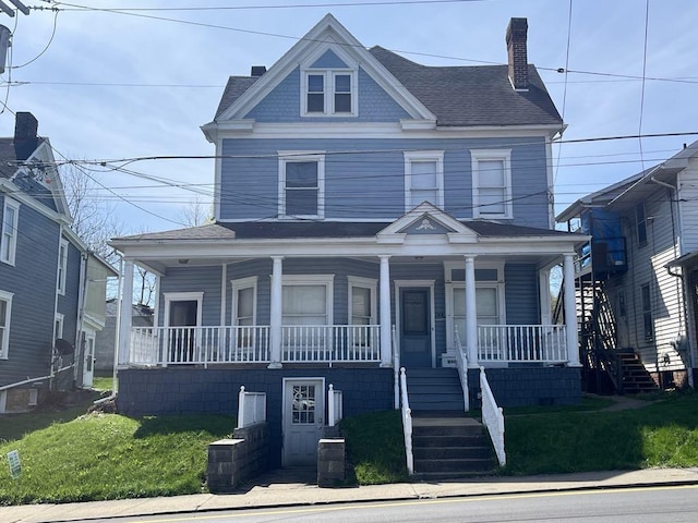 768 E High St, Waynsbrg/Frankln Twp, PA 15370 - view of front facade featuring a front yard, covered porch, and a chimney