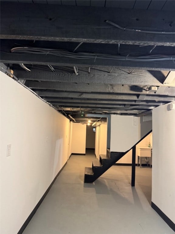 unfinished basement featuring baseboards