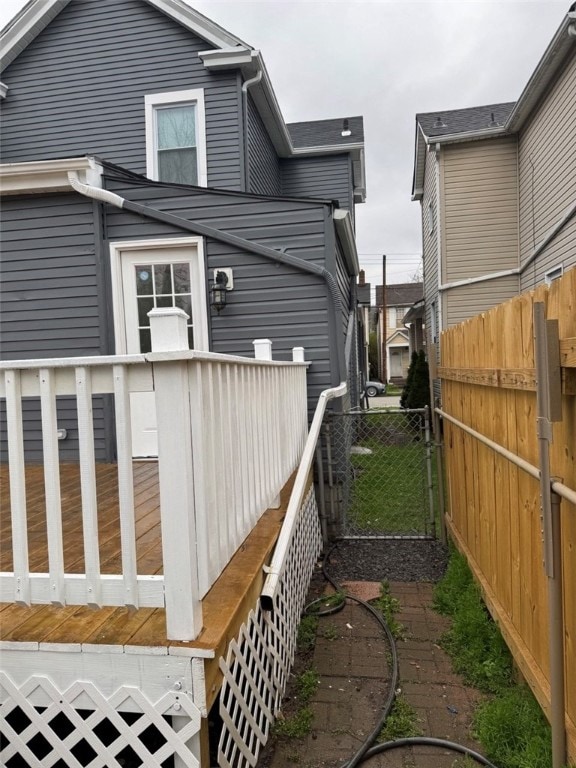 view of home's exterior featuring a deck and fence