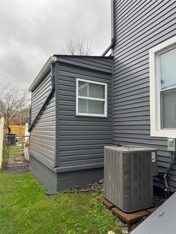 view of home's exterior with fence and central AC unit