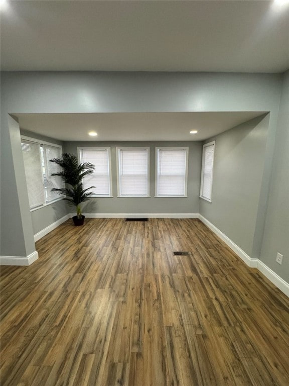 interior space with wood finished floors, recessed lighting, and baseboards
