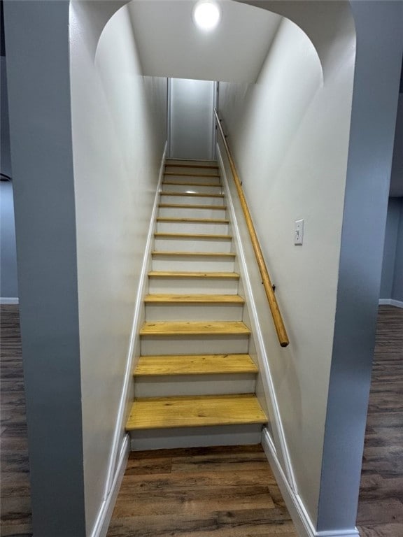 stairs featuring baseboards and wood finished floors