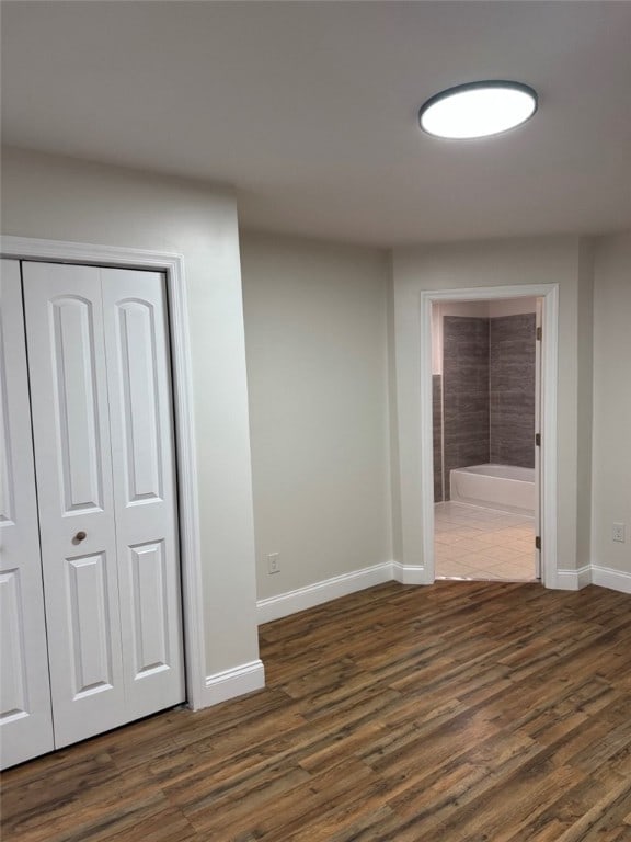 interior space with dark wood-style flooring and baseboards