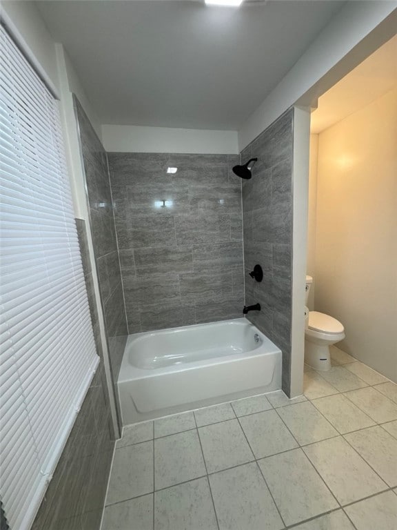 full bath with tub / shower combination, toilet, and tile patterned flooring