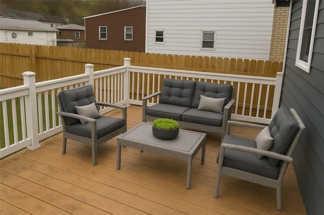wooden terrace with outdoor lounge area and a fenced backyard