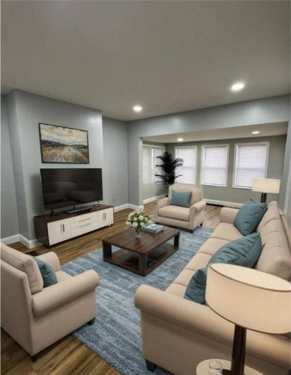 living area featuring wood finished floors, recessed lighting, and baseboards