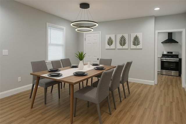 dining area featuring a chandelier, baseboards, light wood-style floors, and recessed lighting