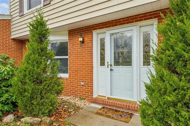 entrance to property with brick siding