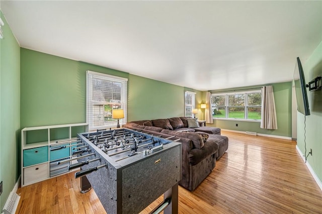 living area featuring wood finished floors, baseboards, and visible vents