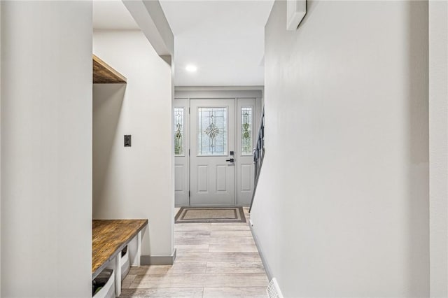 mudroom with light wood finished floors, baseboards, visible vents, and recessed lighting