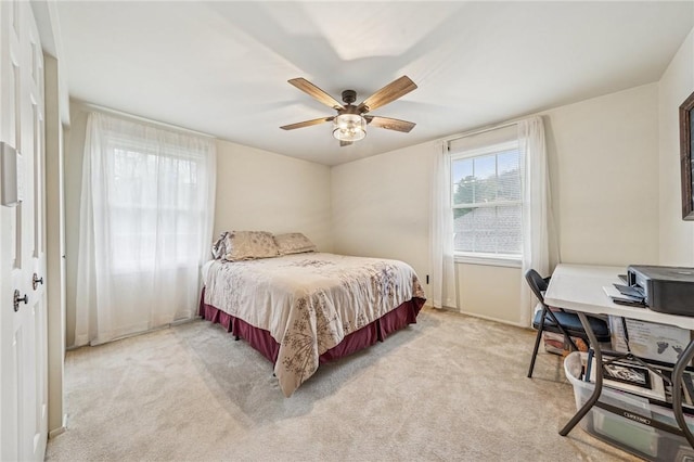 bedroom featuring light colored carpet and ceiling fan