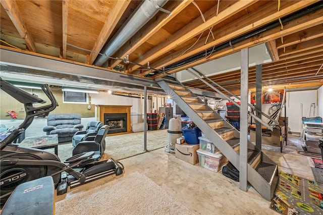 basement with stairway and a fireplace