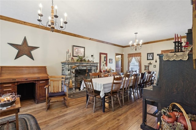 56 Hicks Rd, Donegal Twp Wsh, PA 15376 - dining area with a chandelier, wood finished floors, ornamental molding, and a fireplace